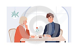 Couple of young man and woman sitting and talking in modern cafe on date. Meeting of two people for cup of coffee in