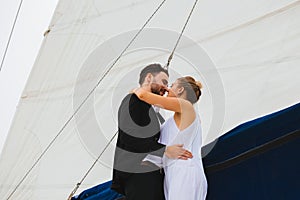 Couple of young people kissing on yacht