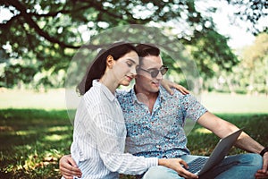 Couple young teen lover sitting and using laptop computer together at park,Romantic and enjoying in moment of happiness time,Happy