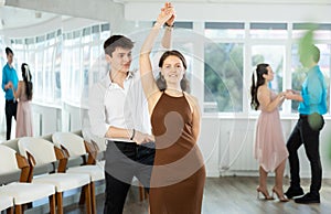 Couple young woman and man dancing waltz