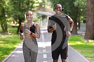 Couples Active Leisure. Cheerful Black Guy And Girl Jogging In Park Together