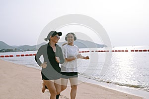 couples asian woman running on sea beach with happiness