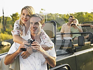 Couples With Binoculars In Jeep