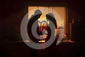 Couples Creating HeartShaped Shadow Puppets on