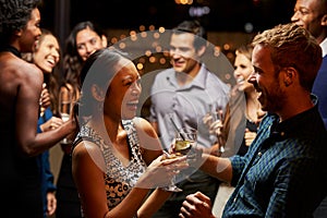 Couples Dancing And Drinking At Evening Party