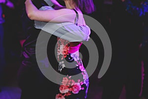 Couples dancing traditional latin argentinian dance milonga in the ballroom, tango salsa bachata kizomba lesson in the red and