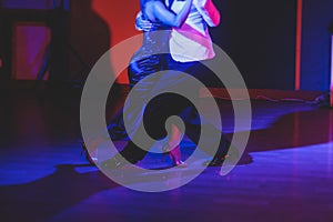 Couples dancing traditional latin argentinian dance milonga in the ballroom, tango salsa bachata kizomba lesson in the red and