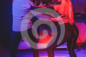 Couples dancing traditional latin argentinian dance milonga in the ballroom, tango salsa bachata kizomba lesson in the red and