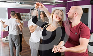 Couples enjoying of partner dance