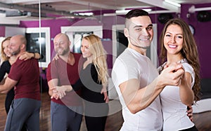 Couples enjoying of partner dance