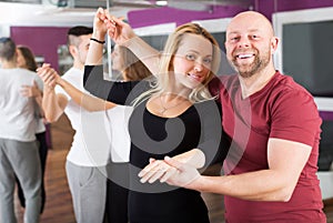Couples enjoying of partner dance photo