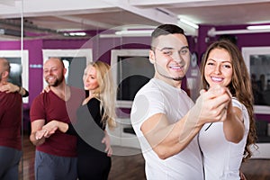 Couples enjoying of partner dance photo