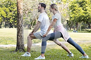 Couples are exercising in the park.