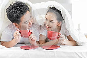 Couples having breakfast on bed