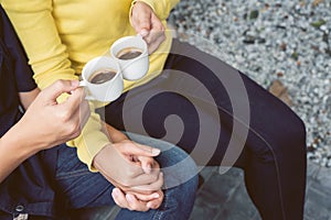 Couples holding hands and drinking coffee in the garden