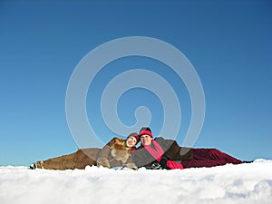 Couples lies on snow