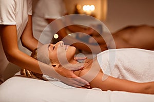 Couples Massage At Spa, Girlfriend And Boyfriend Enjoying Relaxing Treatment