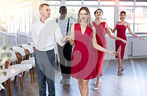 Couples of men and women dancing waltz