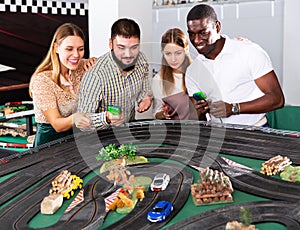 Couples play game slot car racing track
