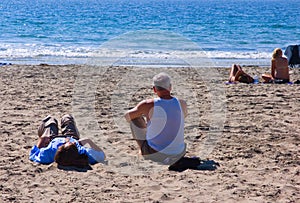 Couples on sandy beach