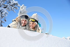 Couples of skiers lying in the snow