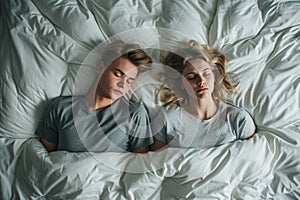 A Couples Sleep Troubles Cause Frustration And Exhaustion, Captured From Above Standard