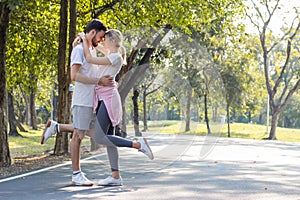 Couples standing kiss and hugging in the park