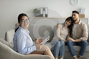 Couples therapy. Portrait of happy arab marital counselor at office after effective session with middle eastern spouses