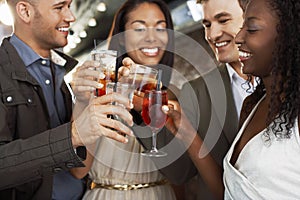 Couples Toasting Drinks At Bar