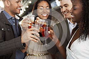 Couples Toasting Drinks At Bar photo