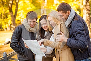 Couples with tourist map in autumn park