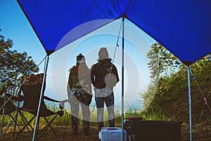 Couples travel camping tent in the holiday. Travel honeymoon couple happy and enjoying a beautiful nature on peak of foggy