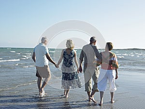 Couples Walking Together On Tropical Beach