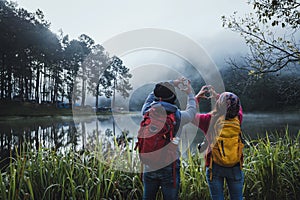 Couples who love to travel, take pictures Beatiful nature at Pang ung lake and pine forest at Mae Hong Son in Thailand