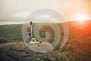 couples of young traveling man and woman relaxing trekking on rock cliff use for people activities ,leisure lifestyle