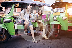 couples of young traveling people sitting on tuk tuk bangkok thailand