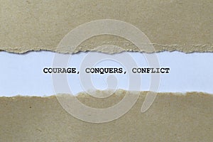 courage conquers conflict on white paper photo