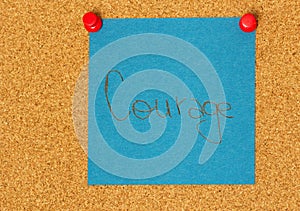 Courage post-it on a coarkboard background