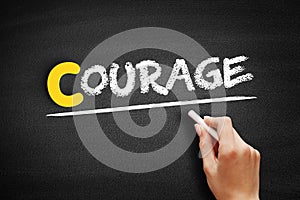 Courage text on blackboard