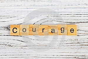 COURAGE word made with wooden blocks concept