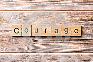 Courage word written on wood block. Courage text on wooden table for your desing, concept