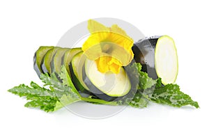 Courgette cut into slices with flower and leaves on white