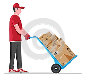 Courier with barrow full of boxes isolated