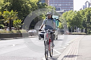 Courier On Bike Delivering Food In City