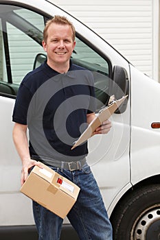 Courier Delivering Package Standing Next To Van