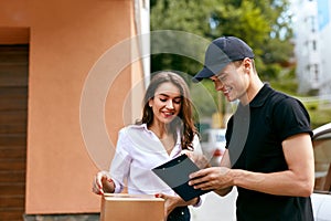 Courier Delivering Package To Woman At Home