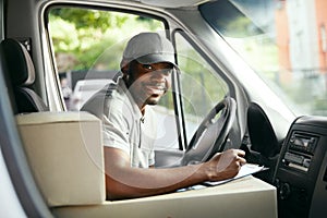 Courier Delivery. Black Man Driver Driving Delivery Car photo