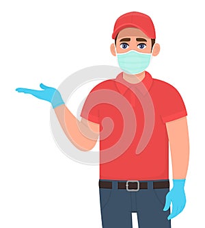 Courier or delivery man in safety medical mask, gloves showing hand to copy space. Man introducing something. Person pointing