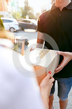 Courier Delivery Service. Closeup Hands Receiving Package