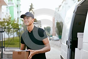 Courier Delivery Service. Man With Box Near Car Outdoors